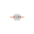 Rose gold ring with a large diamond on a person's finger