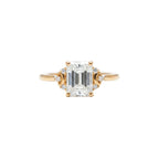 Rose gold ring with a large diamond held between fingers