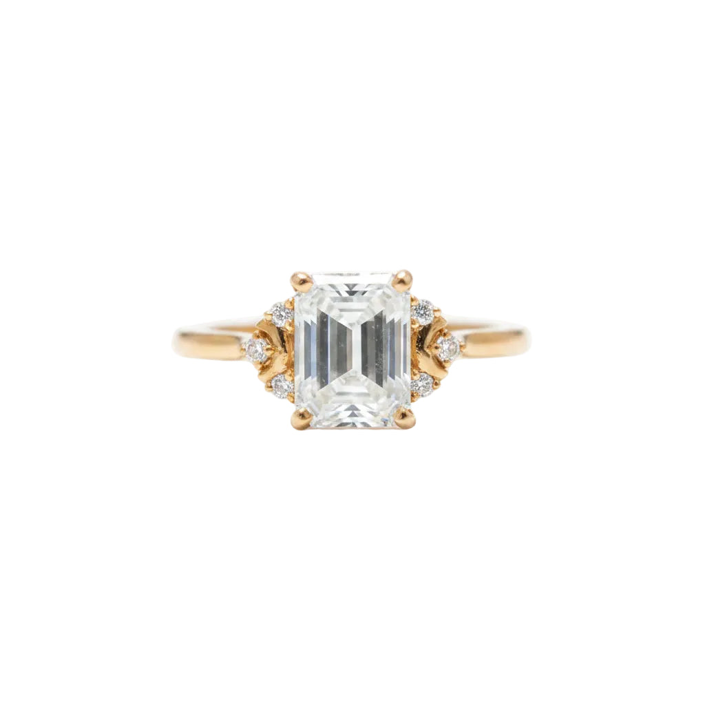 Rose gold ring with a large diamond held between fingers
