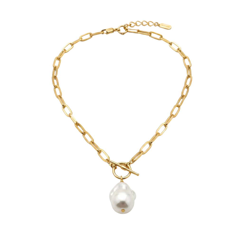 Gold chain necklace with a pearl pendant worn by a person in a white shirt.